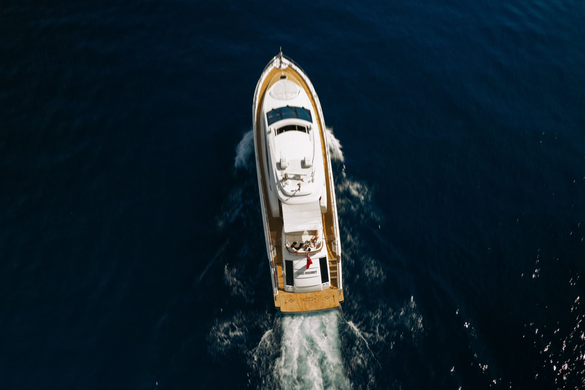 Top-down drone shot of Sans Regret with name visible on the stern