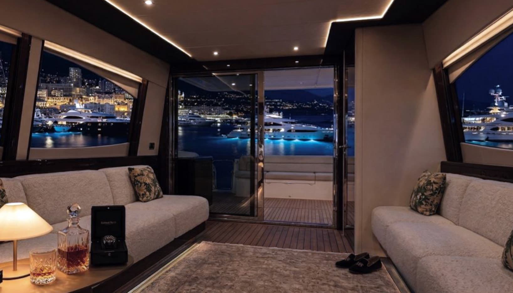 Main salon at night with Monaco harbour views